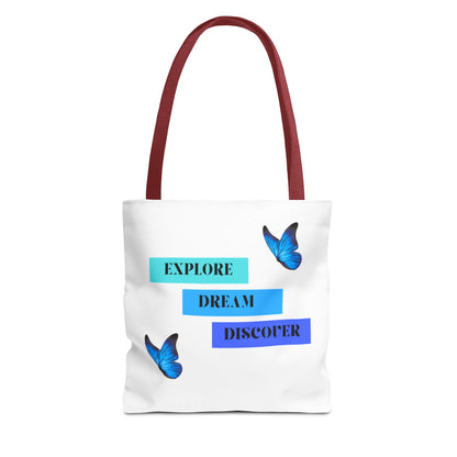 Stylish white Explore, Dream, Discover tote bag with red handles, featuring a motivational design with butterflies. This 100% polyester tote is ideal for daily use, shopping, or as an eco-friendly option. Available in sizes 13"x13", 16"x16", 18"x18". Luminous Gem Designs.