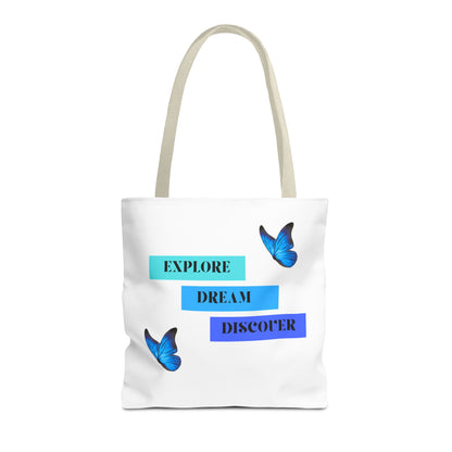 White Explore, Dream, Discover tote bag with beige handles, featuring inspirational words and butterfly designs. Crafted from 100% polyester for durability, this stylish tote is ideal for daily errands and shopping. Available in sizes 13"x13", 16"x16", 18"x18". Luminous Gem Designs.