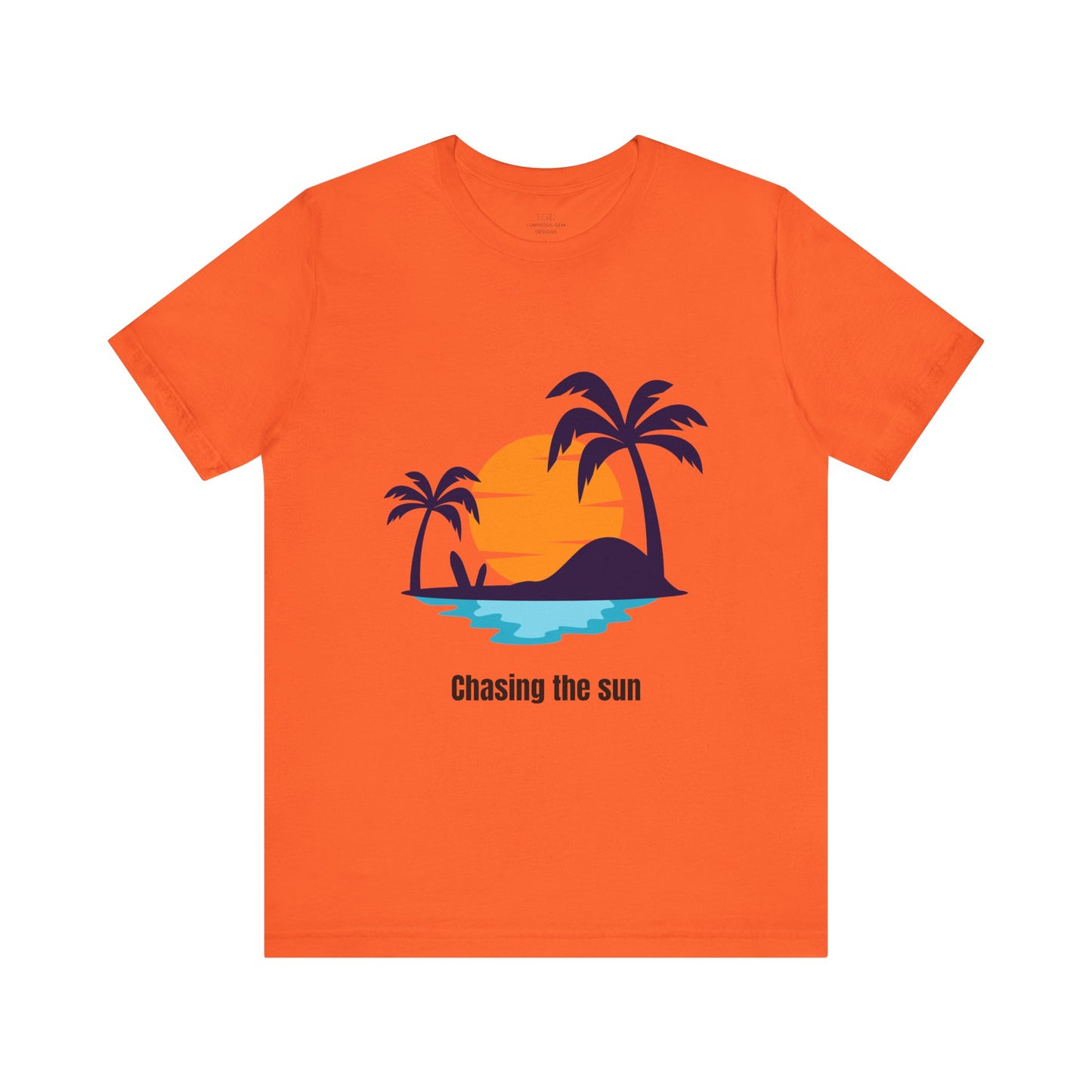 Vibrant orange "Chasing the Sun" T-shirt, perfect for summer vibes and travel lovers. Made from soft, breathable cotton for all-day comfort. Sizes: XS, S, M, L, XL, 2XL, 3XL. Luminous Gem Designs