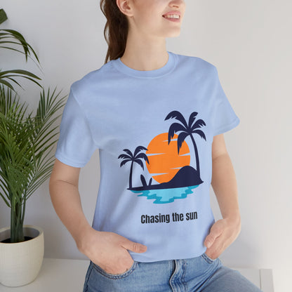 Comfy and trendy blue "Chasing the Sun" T-shirt with a scenic island and palm tree design. Perfect for beach lovers and summer adventures. Soft, breathable cotton with a relaxed crew neck fit. Available in XS, S, M, L, XL, 2XL, 3XL. Luminous Gem Designs