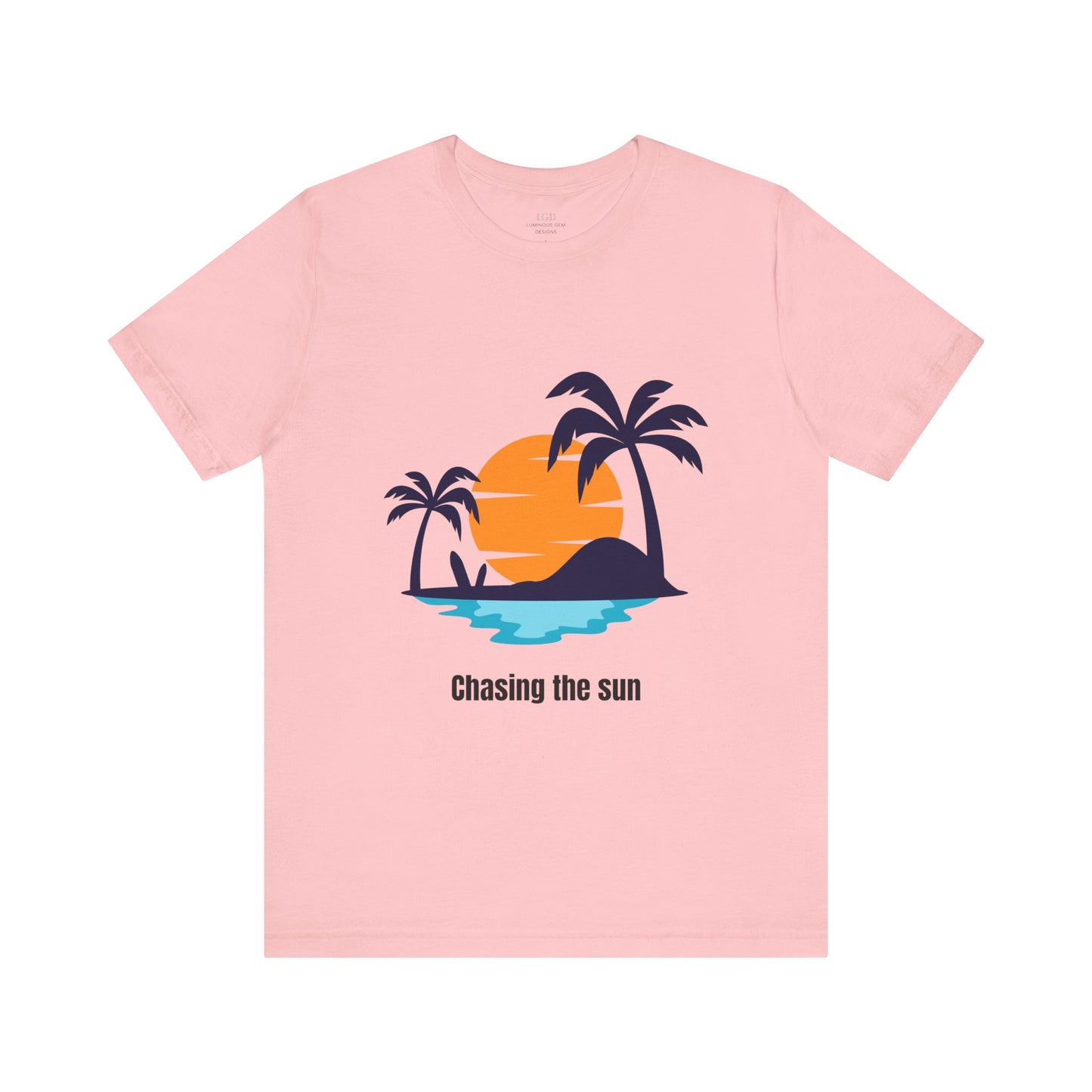 Trendy pink "Chasing the Sun" T-shirt designed for sun chasers and adventure seekers. Cozy, stylish, and perfect for casual wear. Available in XS, S, M, L, XL, 2XL, 3XL. Luminous Gem Designs