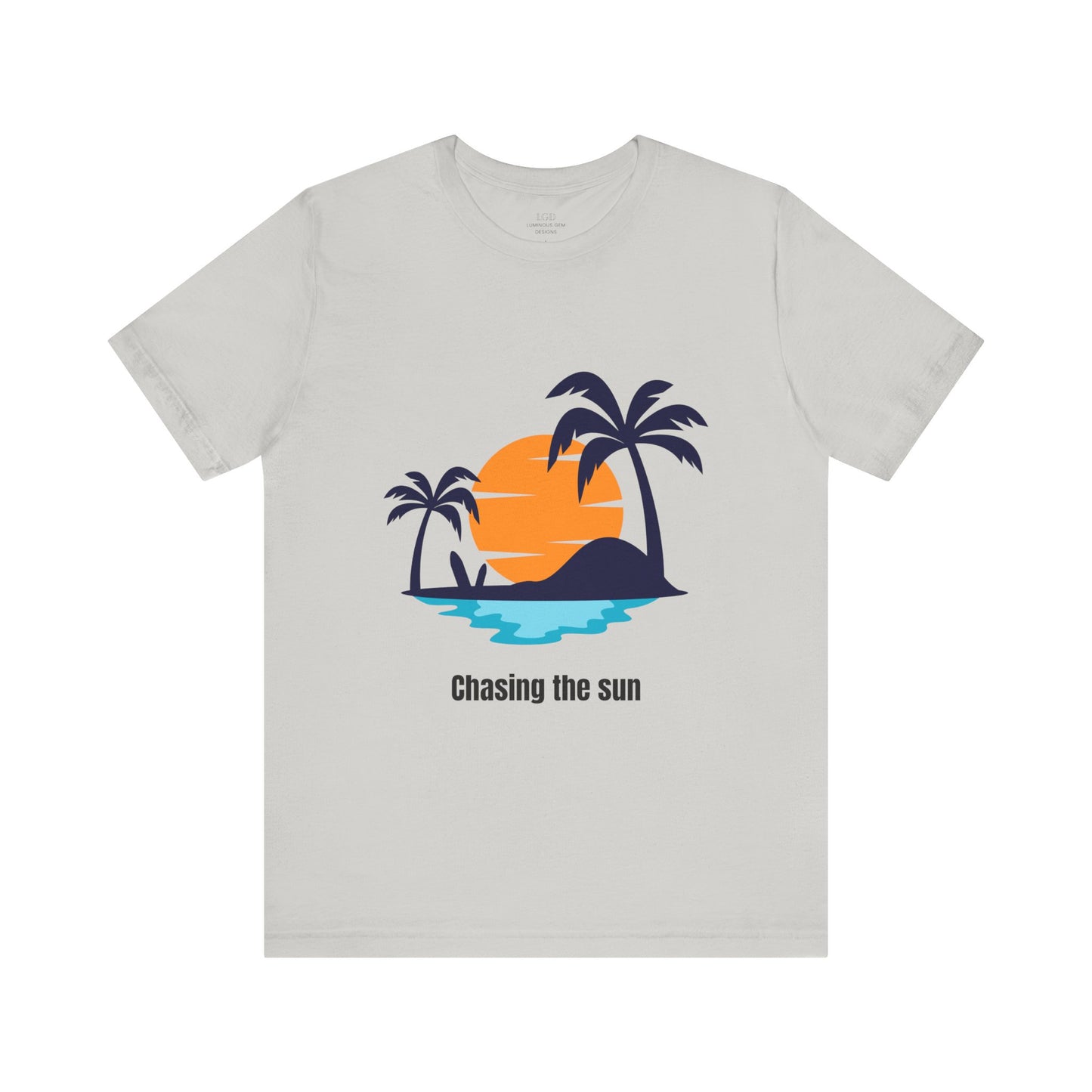 Modern silver "Chasing the Sun" T-shirt for a sleek summer look. Lightweight, breathable, and trendy for casual outings. Available in XS, S, M, L, XL, 2XL, 3XL. Luminous Gem Designs