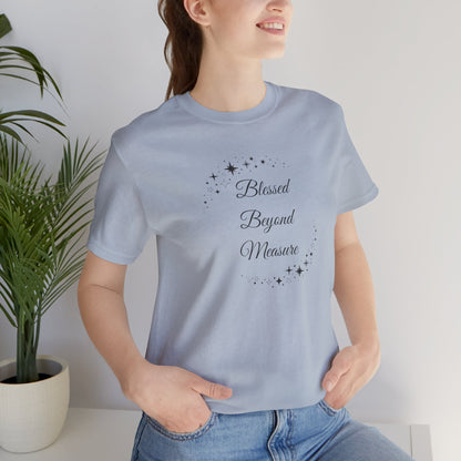 Woman wearing Uplifting light blue "Blessed Beyond Measure" T-shirt with whimsical star designs. Soft, breathable, and comfortable—perfect for casual wear and faith-based gifts. Sizes: XS, S, M, L, XL, 2XL, 3XL. Luminous Gem Designs.