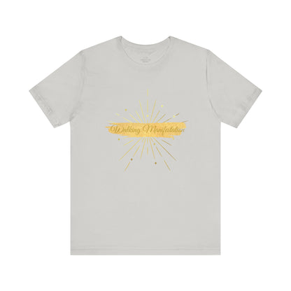 Elegant silver "Walking Manifestation" T-shirt with a striking gold design. A must-have for those who radiate self-confidence and positivity. Sizes: XS, S, M, L, XL, 2XL, 3XL. Luminous Gem Designs.