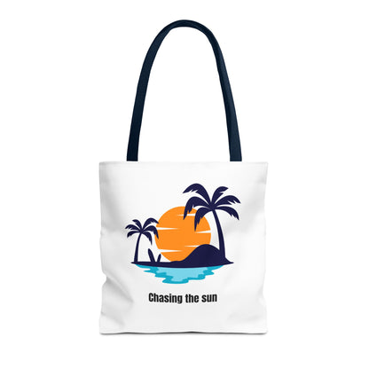 Chasing the Sun tote bag in white with navy handles, featuring a vibrant tropical palm tree design. Made from 100% polyester for durability and quick drying, perfect for casual outings. Available in sizes 13"x13", 16"x16", 18"x18". Luminous Gem Designs.