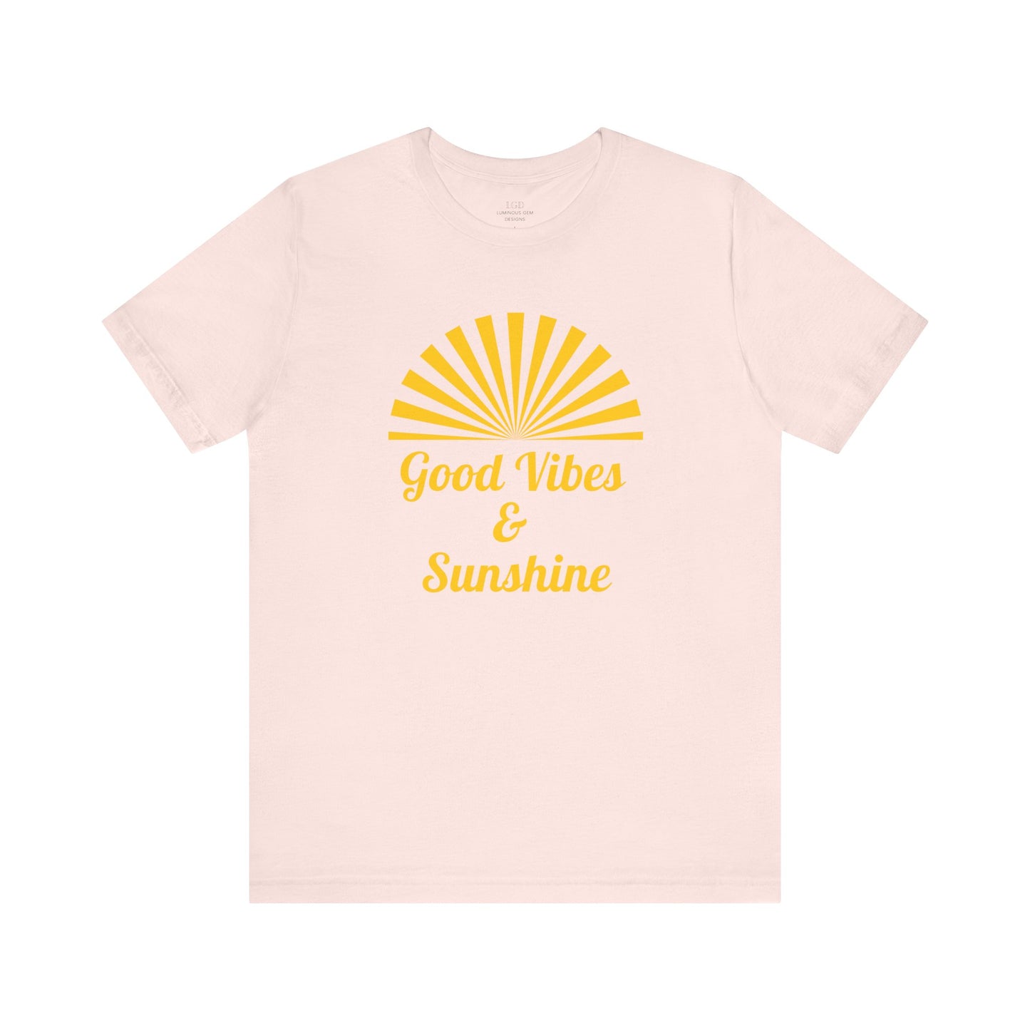 Soft pink Good Vibes and Sunshine Unisex T-shirt with a vibrant sunshine graphic and Good Vibes quote. Crafted from 100% Airlume combed and ring-spun cotton, ensuring a comfortable fit for everyday wear. Sizes: XS, S, M, L, XL, 2XL, 3XL. Luminous Gem Designs.