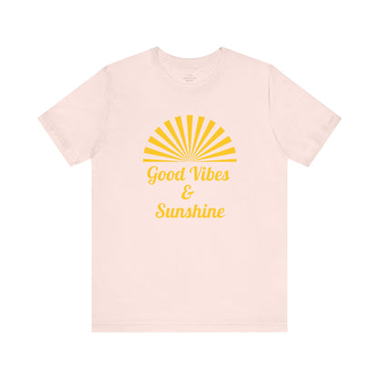 Soft pink Good Vibes and Sunshine Unisex T-shirt with a vibrant sunshine graphic and Good Vibes quote. Crafted from 100% Airlume combed and ring-spun cotton, ensuring a comfortable fit for everyday wear. Sizes: XS, S, M, L, XL, 2XL, 3XL. Luminous Gem Designs.